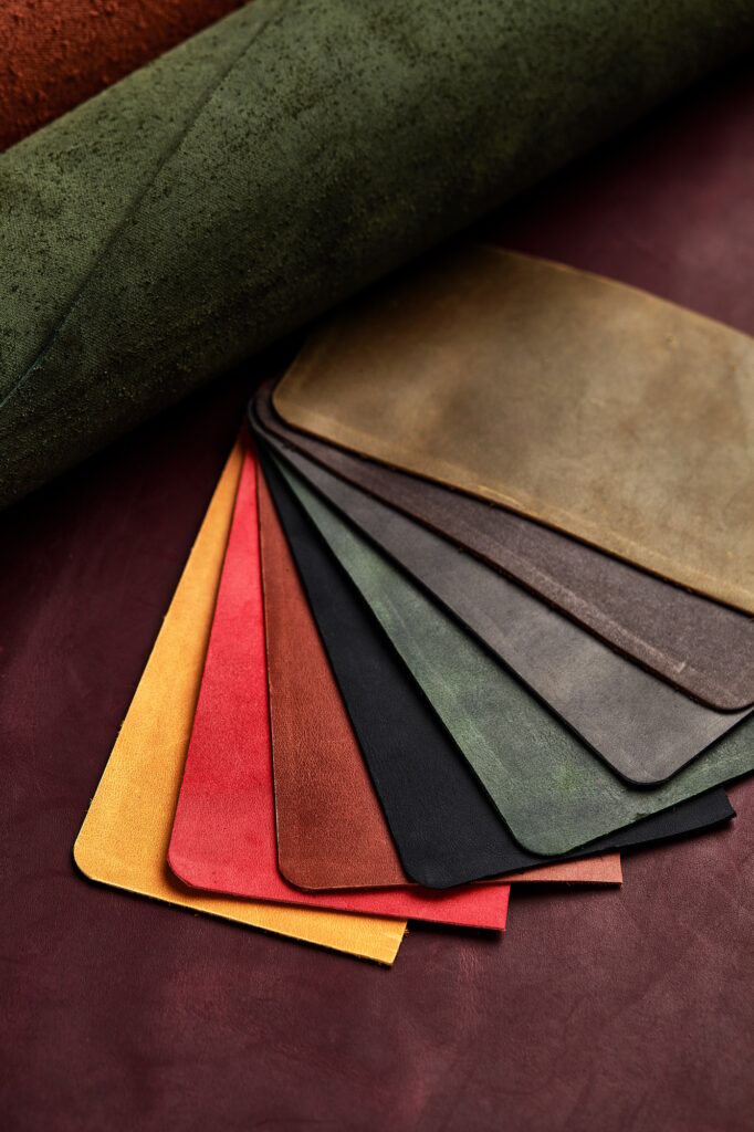 Artificial leather samples on a cow leather background. Top view.